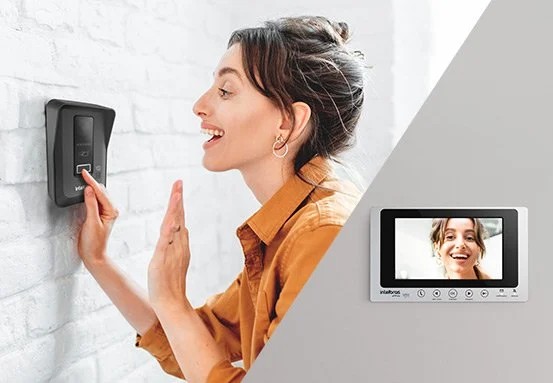 Pessoa utilizando interfone com monitor de vídeo